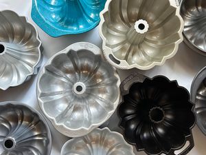 A group of Bundt pans on a white surface