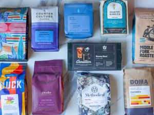 A number of coffee bags on a kitchen countertop.