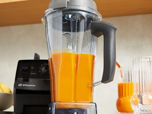 Vitamix 5200 Professional-Grade Blender filled with orange smoothie