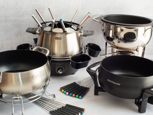 Four fondue posts on a light grey countertop.