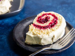 Jelly roll on a plate with a fork.