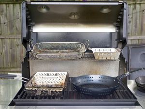 grill baskets on an open gas grill