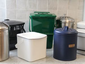 A collection of compost bins on a marble countertop