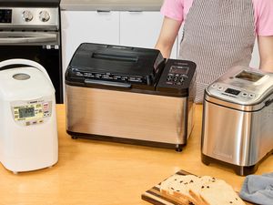 Three bread machines on a countertop