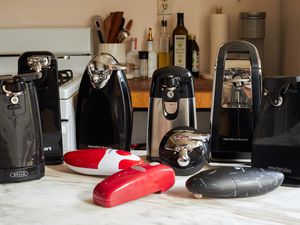 A group of electric can openers on a kitchen countertop