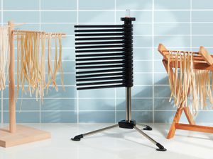 three pasta drying racks on a kitchen countertop