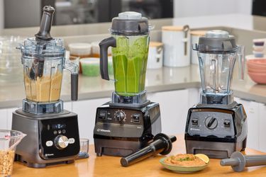 Three Vitamix blenders on a kitchen countertop.