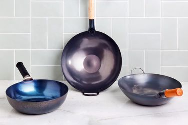 Best carbon steel woks displayed on marble counter