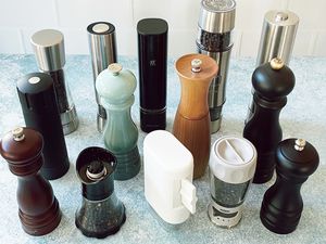 Assortment of pepper mills on a blue surface