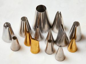 A collection of piping tips of various sizes and shapes.