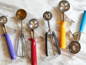 Six portion scoops on a marble countertop