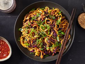  Stir-fried lo mein noodles with pork and vegetables served on a platter