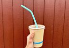 A to-go drink cup with a silicone reusable straw in it