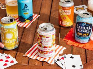 a variety of non alcoholic beers on a table with napkins and cards