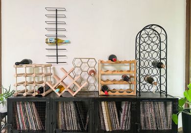 A variety of wine racks displayed on top of a record player