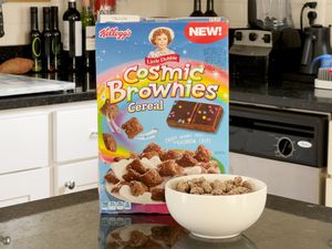 Box of Kellog's Little Debbie Cosmic Brownies Cereal on a counter with a bowl filled with the cereal in the foreground