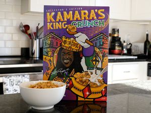 Box of Kamara's King Crunch cereal on a counter with a bowl filled with the cereal in front of it