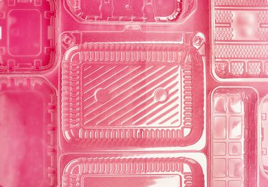 plastic clamshell containers on a pink background