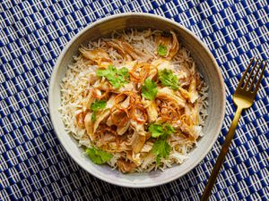 Overhead view of taiwanese turkey and rice on a blue and white stripped background