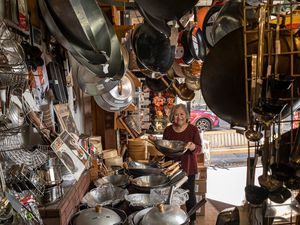 Tane Chan holding a wok in The Wok Shop