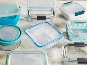 Several food storage containers displayed on a marble counter