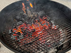 A closeup look at a fiery charcoal grill